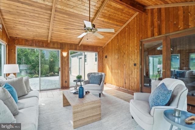 living room with wood ceiling, wooden walls, light tile patterned floors, french doors, and vaulted ceiling with beams