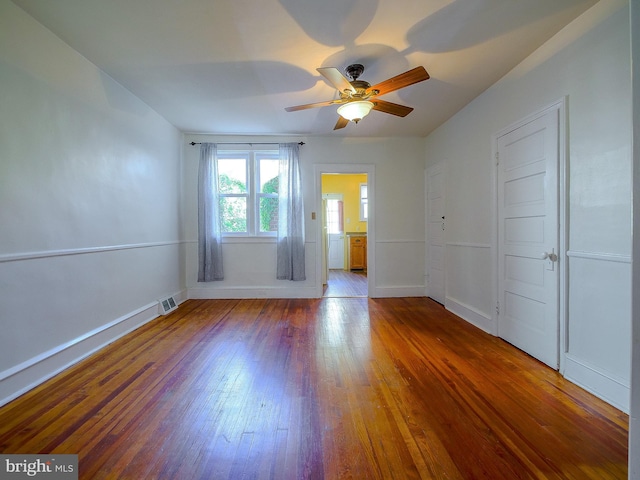 unfurnished room featuring ceiling fan and hardwood / wood-style flooring