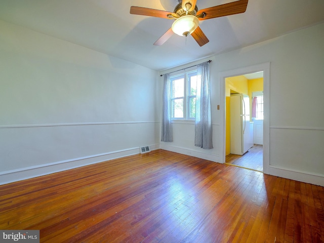 unfurnished room featuring light hardwood / wood-style flooring, plenty of natural light, and ceiling fan