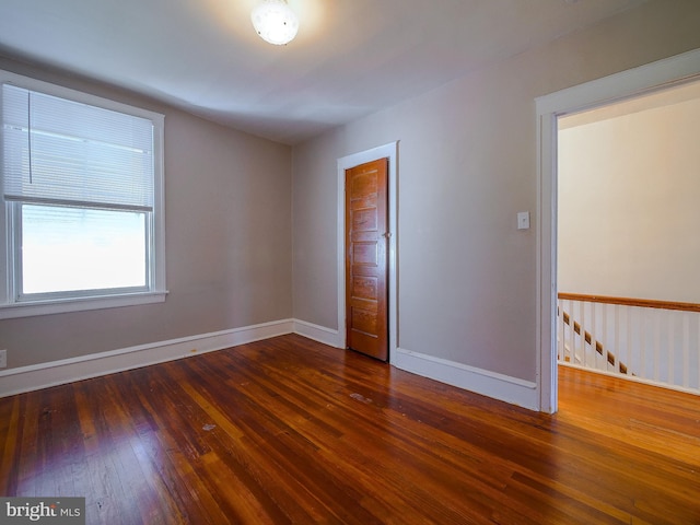 empty room featuring dark hardwood / wood-style flooring