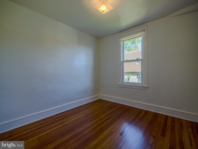 unfurnished room with dark hardwood / wood-style floors