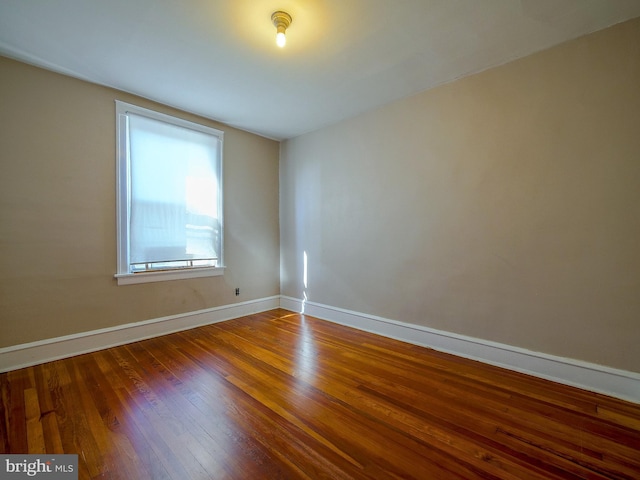 spare room featuring wood-type flooring