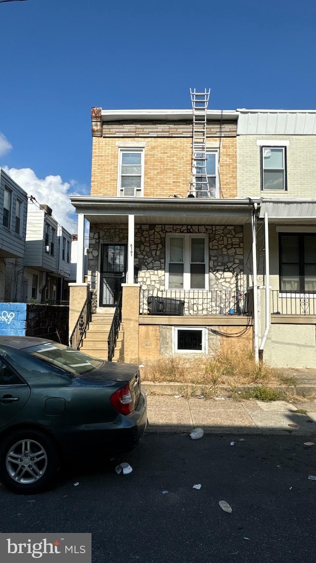 townhome / multi-family property featuring a porch