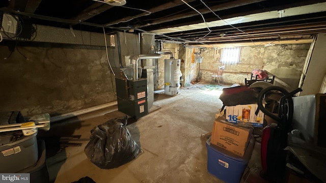 basement featuring heating unit and gas water heater