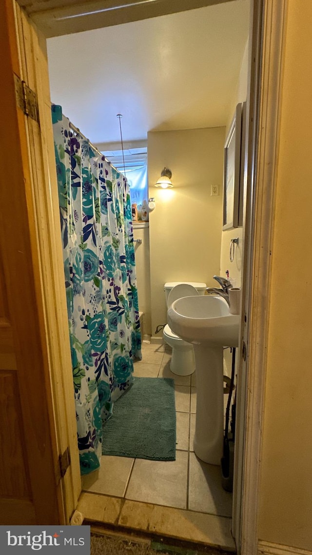 bathroom featuring toilet and tile patterned floors