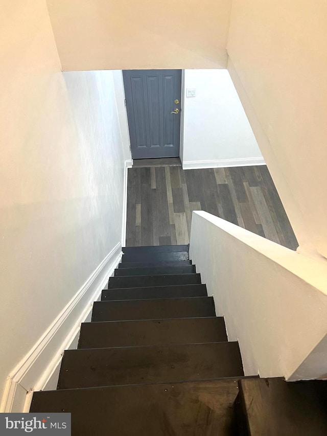 staircase featuring hardwood / wood-style floors