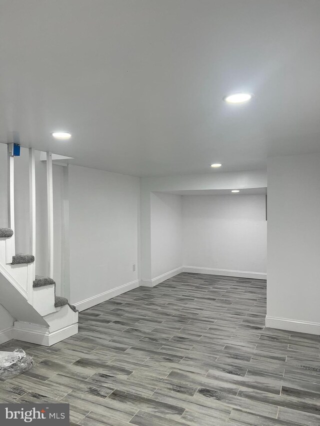 basement with hardwood / wood-style flooring