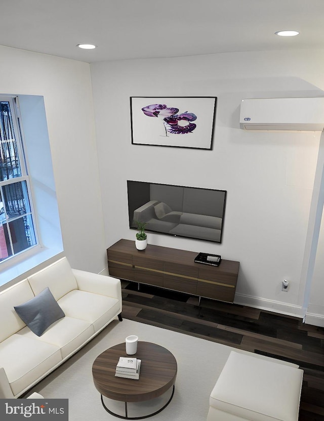 living room with a wall mounted AC and dark wood-type flooring