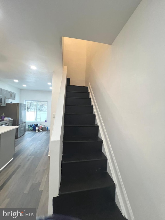 stairway featuring hardwood / wood-style flooring