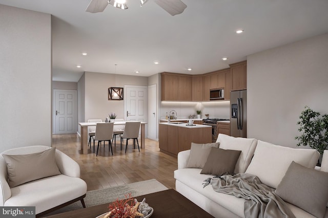 living room featuring light hardwood / wood-style floors, sink, and ceiling fan