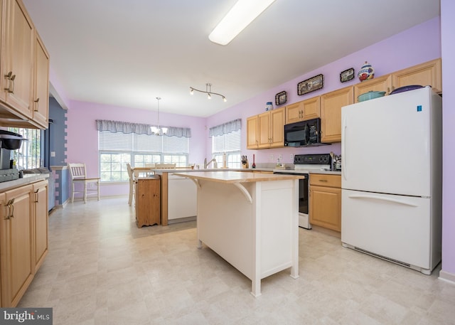 kitchen featuring white appliances, a kitchen island, decorative light fixtures, an inviting chandelier, and a kitchen bar