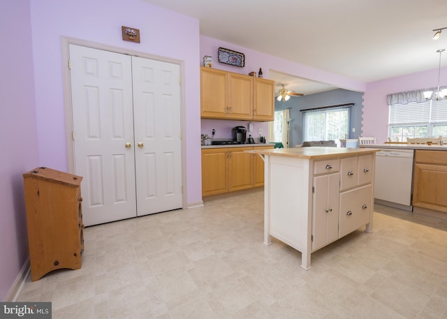 kitchen with white dishwasher, decorative light fixtures, a center island, light brown cabinetry, and ceiling fan with notable chandelier