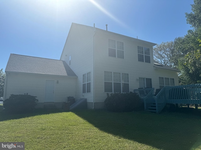 back of house featuring a yard and a wooden deck