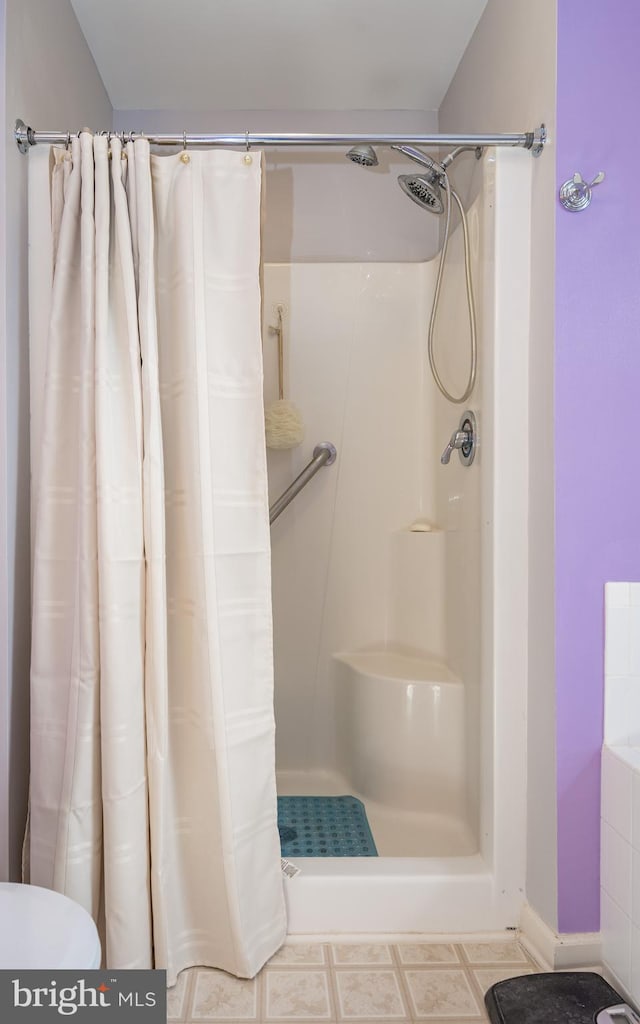 bathroom featuring a shower with shower curtain and toilet