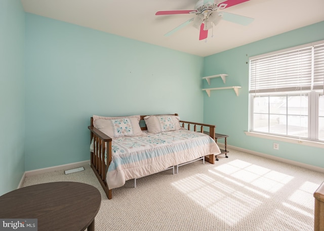 bedroom featuring light colored carpet and ceiling fan