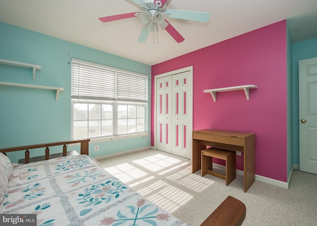 carpeted bedroom featuring ceiling fan and a closet