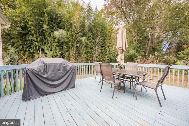 wooden deck with a grill