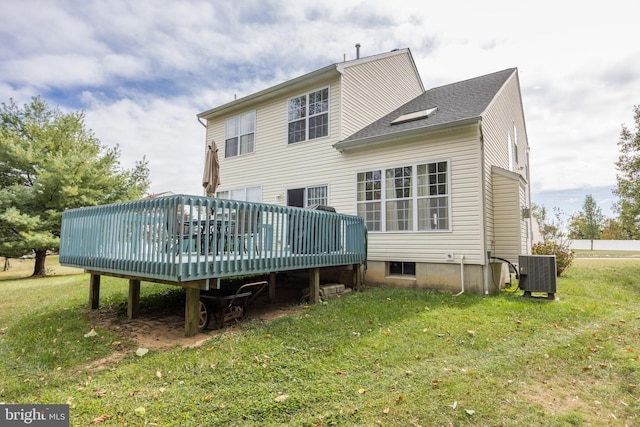 back of house featuring a wooden deck, central AC unit, and a lawn