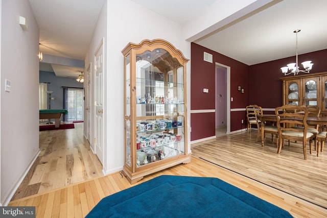 interior space with plenty of natural light, a chandelier, and hardwood / wood-style flooring