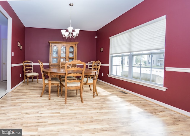 dining room featuring a notable chandelier and light hardwood / wood-style floors