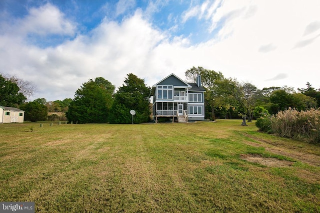 view of yard featuring a sunroom