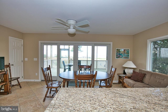 dining space featuring ceiling fan and french doors