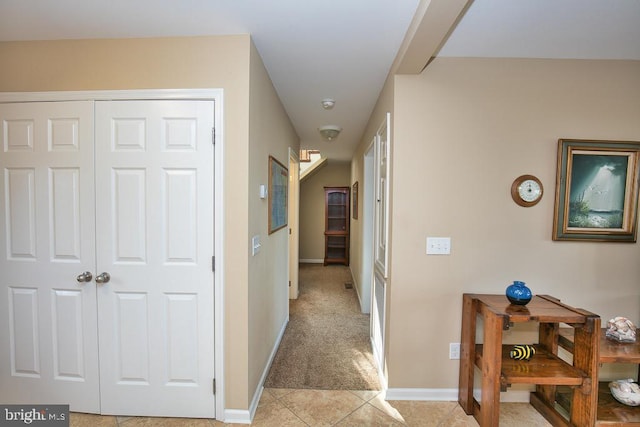 hallway featuring light carpet