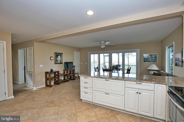 kitchen with light stone counters, white cabinets, light tile patterned flooring, ceiling fan, and stainless steel electric range