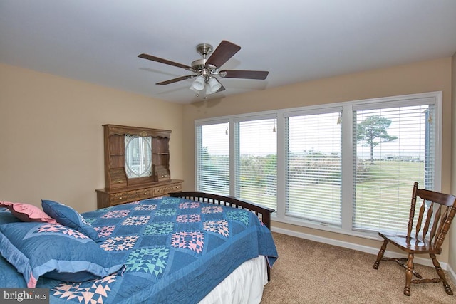 bedroom with light colored carpet, multiple windows, and ceiling fan