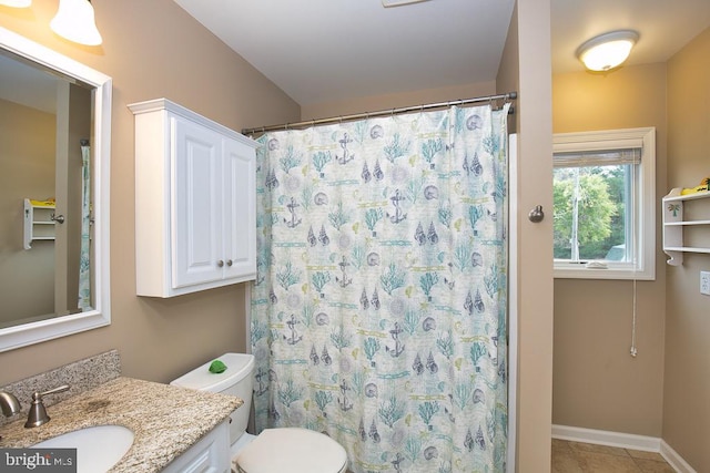 bathroom with tile patterned flooring, curtained shower, vanity, and toilet