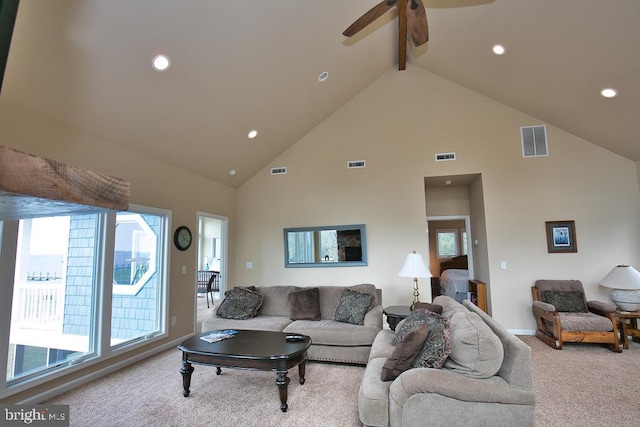 living room featuring high vaulted ceiling, beamed ceiling, ceiling fan, and light colored carpet