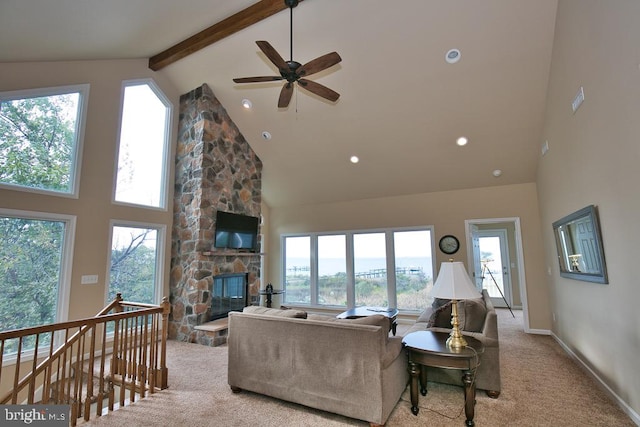 living room featuring high vaulted ceiling, a fireplace, beamed ceiling, and light colored carpet