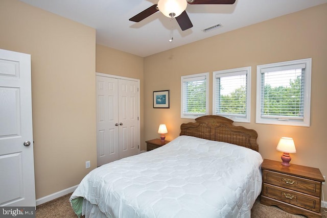 bedroom featuring ceiling fan, a closet, and carpet flooring