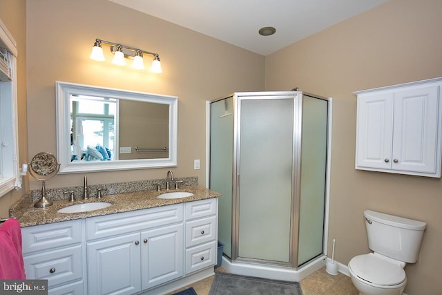 bathroom featuring tile patterned flooring, an enclosed shower, vanity, and toilet