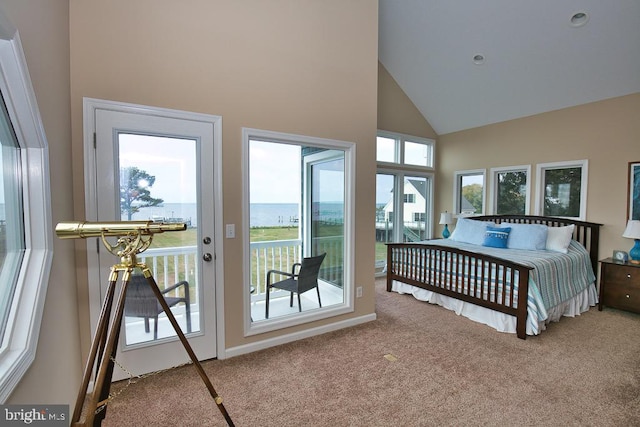 carpeted bedroom featuring a water view, high vaulted ceiling, and access to outside