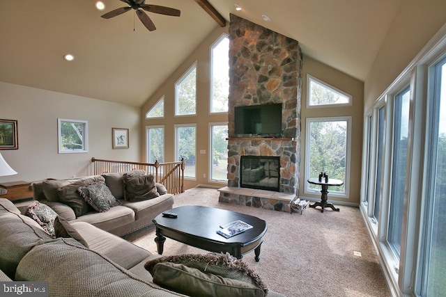 living room featuring carpet flooring, ceiling fan, beam ceiling, a stone fireplace, and high vaulted ceiling