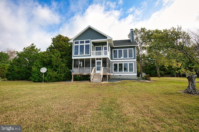 back of house featuring a sunroom and a lawn