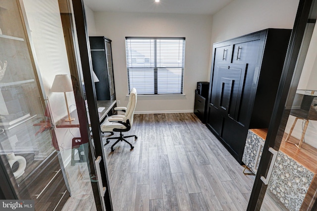 office with light hardwood / wood-style floors