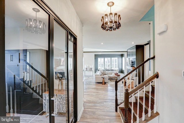 interior space featuring an inviting chandelier and light wood-type flooring