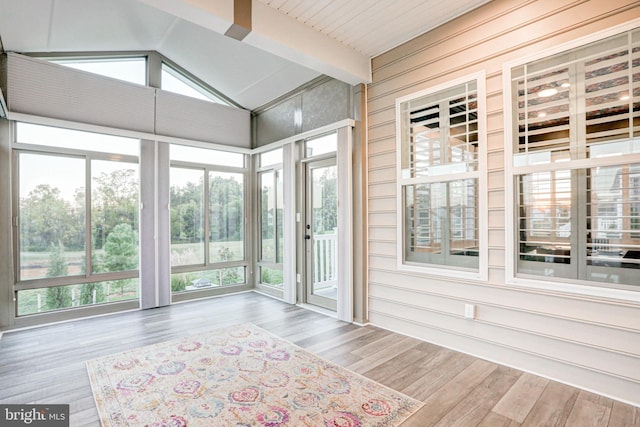 unfurnished sunroom with lofted ceiling with beams