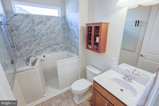 full bathroom featuring tiled shower / bath, vanity, and toilet