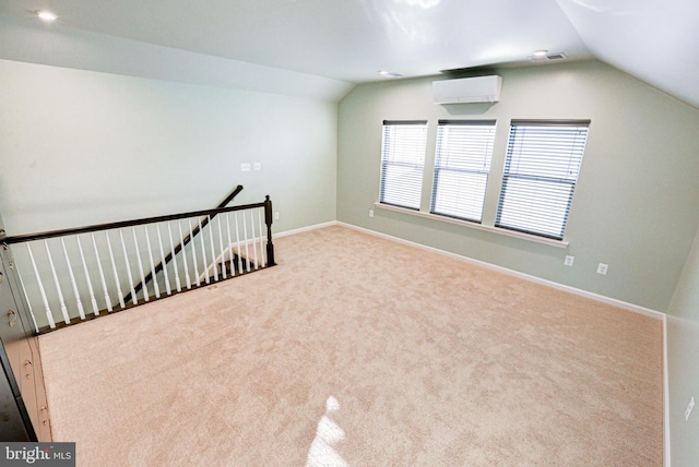 additional living space featuring an AC wall unit, lofted ceiling, and light colored carpet