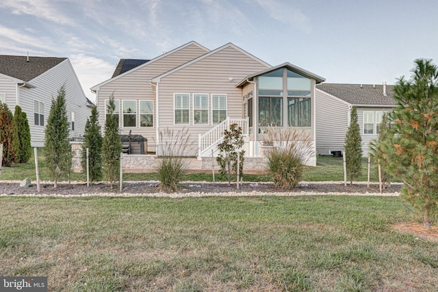 view of front facade with a front lawn and a sunroom