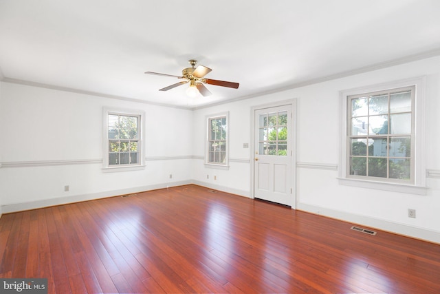 empty room featuring wood-type flooring, ceiling fan, and crown molding