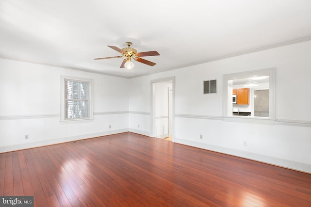 unfurnished room with wood-type flooring, ornamental molding, and ceiling fan