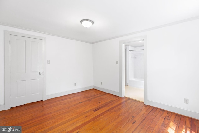 spare room with wood-type flooring