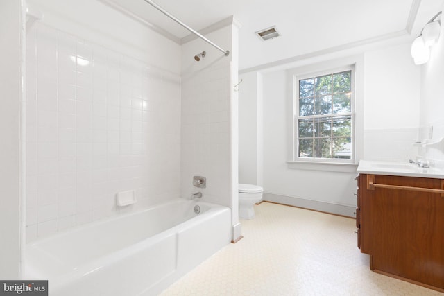 full bathroom featuring crown molding, tiled shower / bath combo, vanity, and toilet