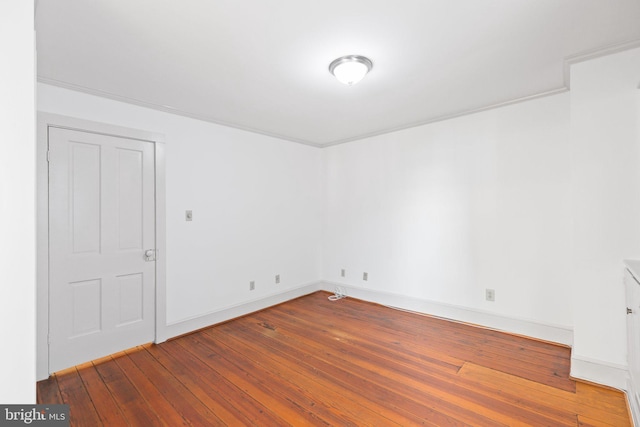 unfurnished room with hardwood / wood-style flooring