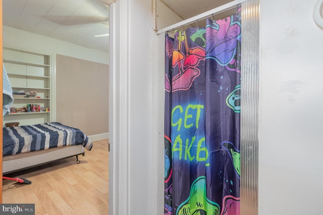 bathroom featuring walk in shower and hardwood / wood-style flooring