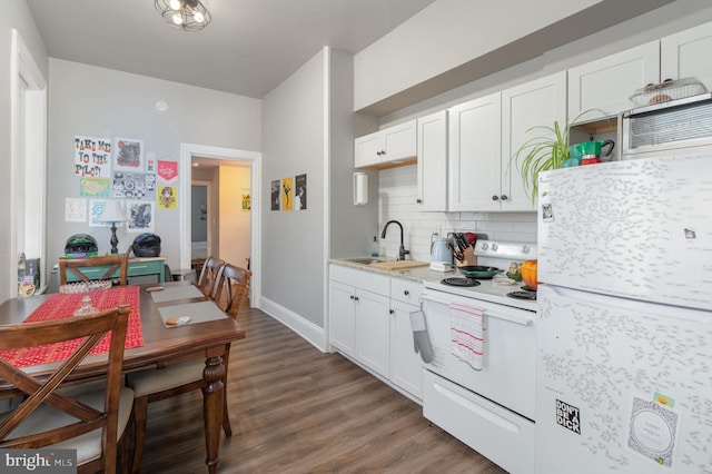 kitchen featuring white cabinets, white appliances, sink, and dark hardwood / wood-style flooring